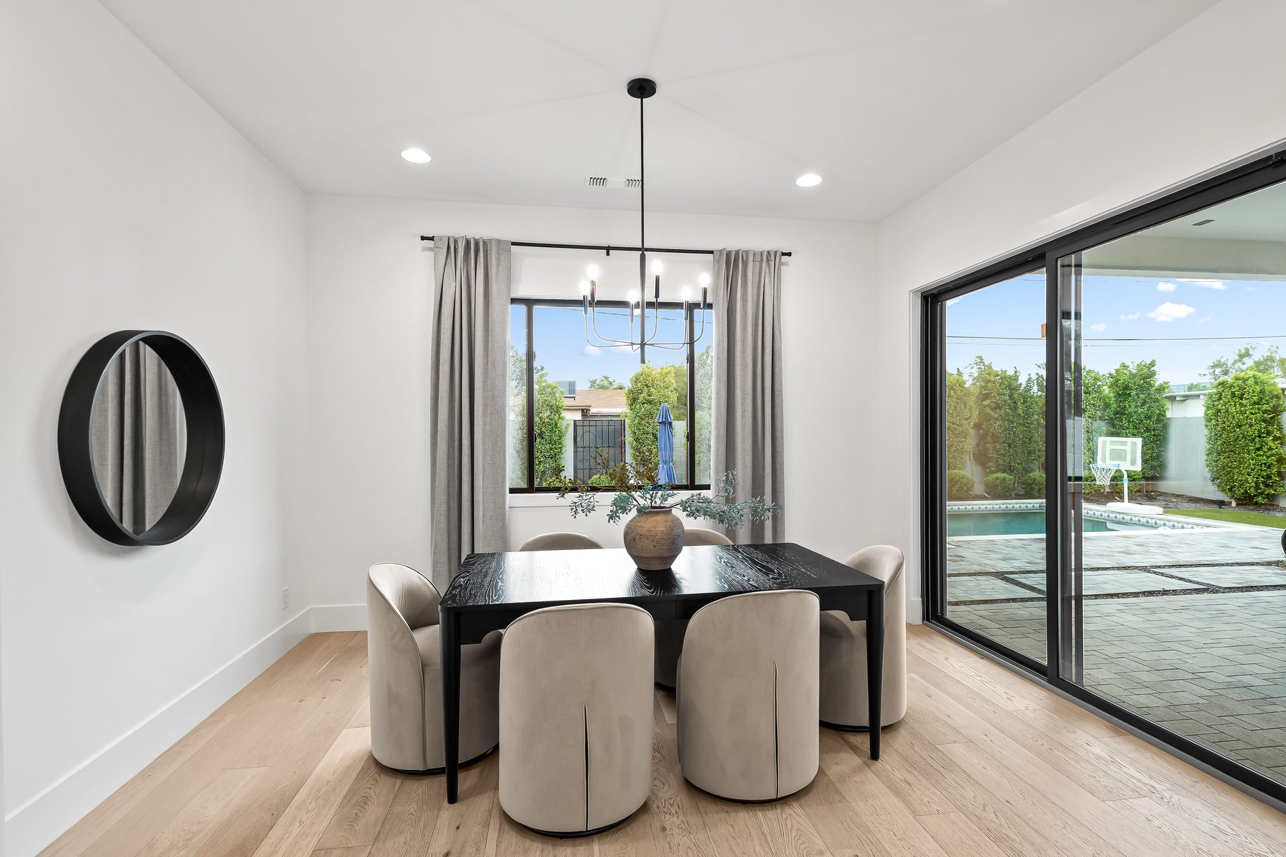 Dining room with chandelier and glass doors to the covered patio and pool, Arcadia, Phoenix