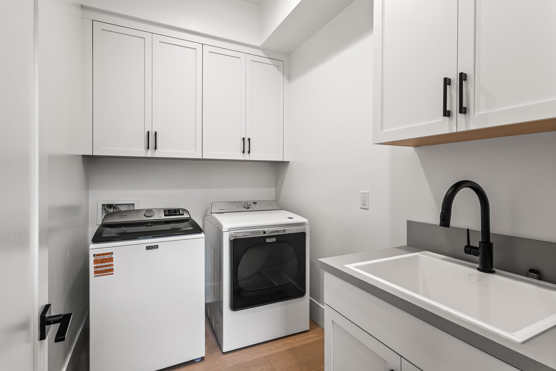 Interior laundry room with washer and dryer space and cabinetry in Lower Arcadia