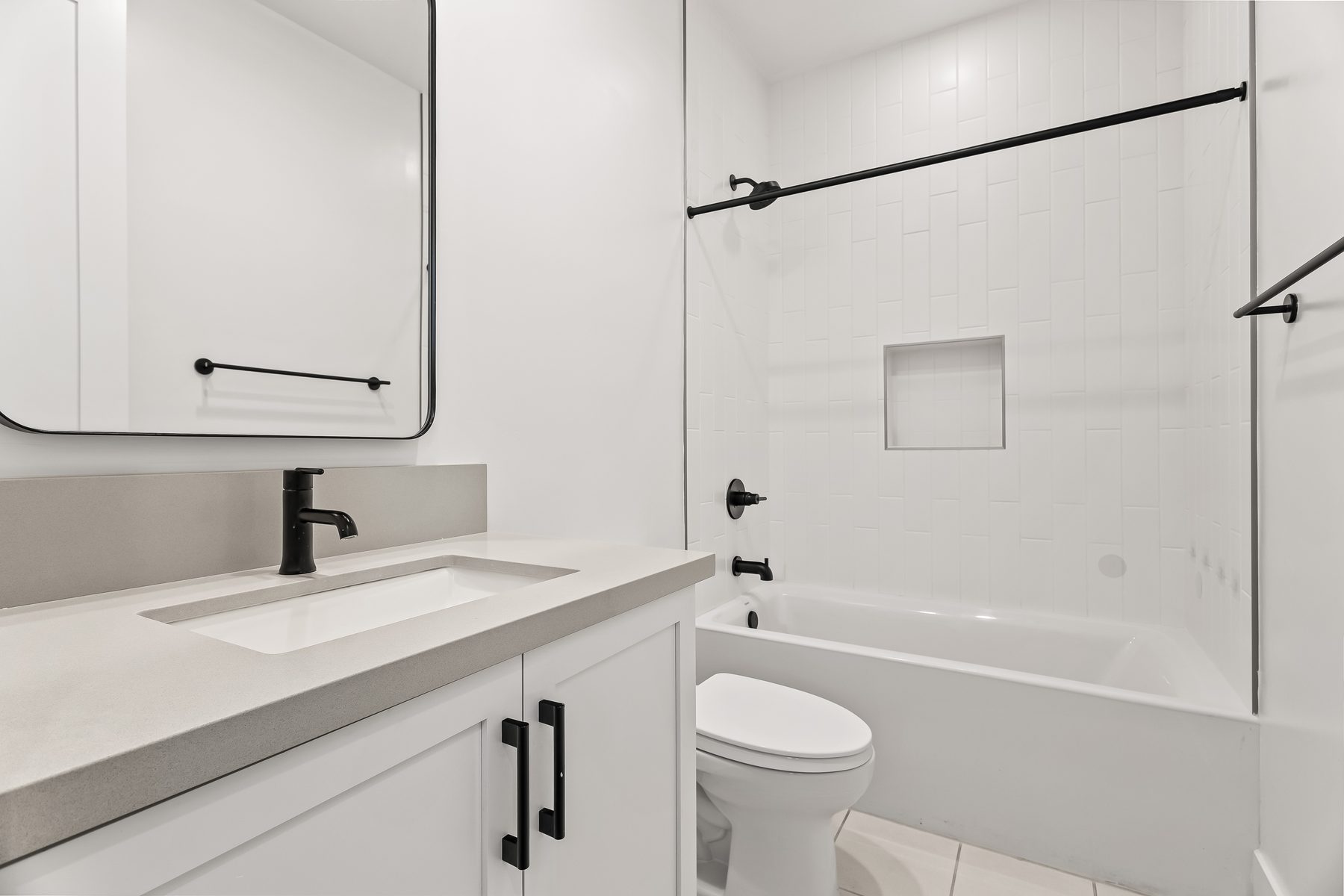 Secondary bathroom with quartz vanity and tub and shower combination in Lower Arcadia